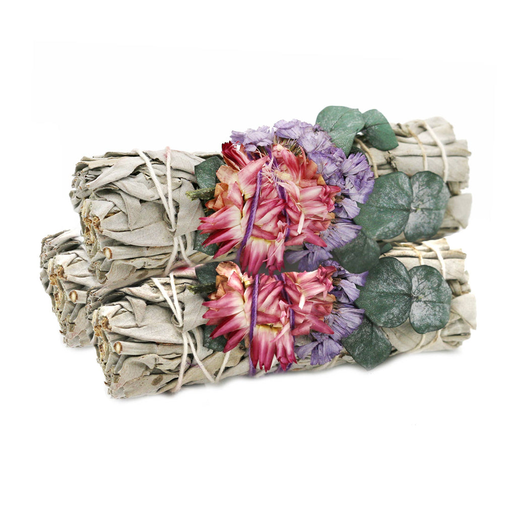 Bundled sage with flowers and leaves on a white background