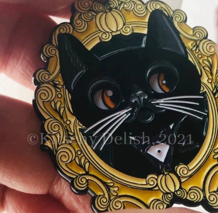 Black cat design on a decorative yellow background