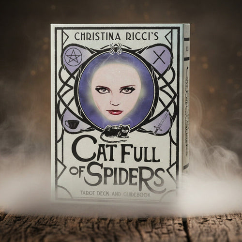 Book titled 'Cat Full of Spiders' by Christina Ricci with a cover featuring a woman's face and a cat.
