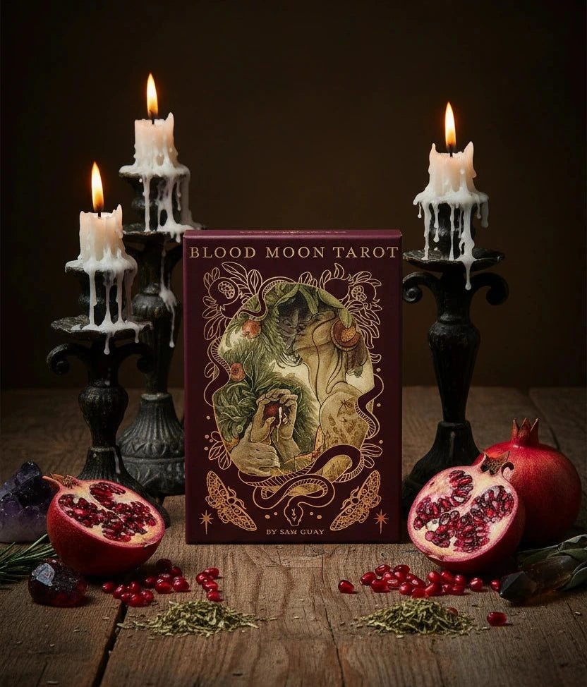 Book cover of 'Blood Moon Tarot' with an illustration of a figure holding a fruit, surrounded by decorative elements.