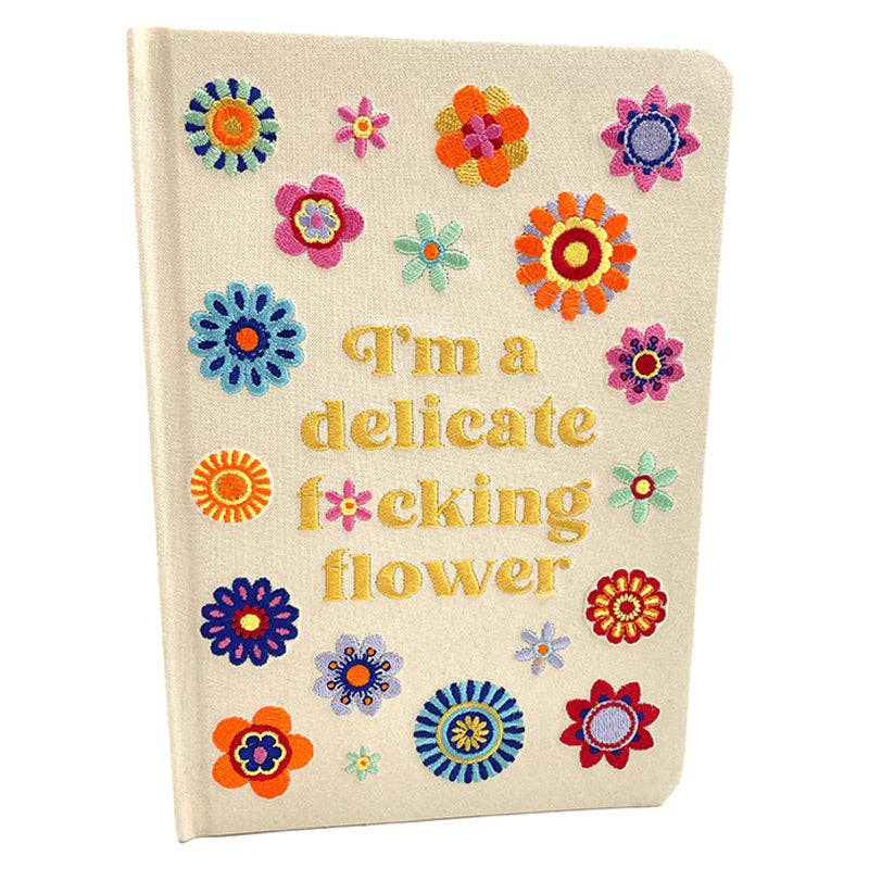Notebook with colorful floral designs and text on a white background