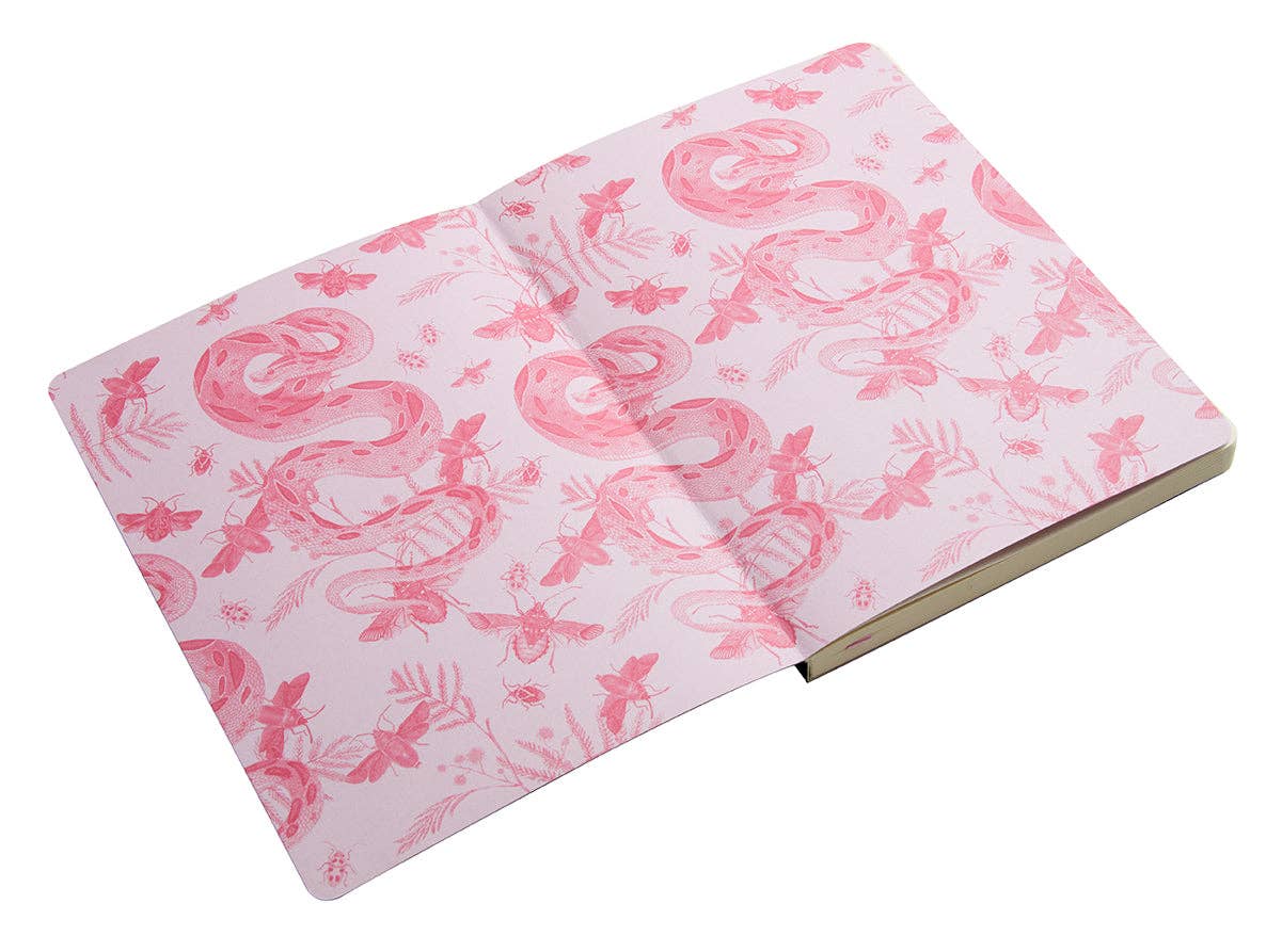 Open notebook with pink flamingo pattern on a white background