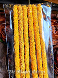 Packaged yellow sandalwood incense sticks with a clear plastic wrap, branded 'The Magick Cabinet'.